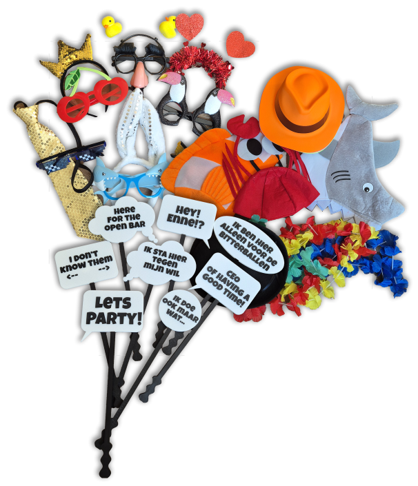 Assorted party photo booth props including masks, hats, glasses, and speech-bubble signs for a fun selfie setup.